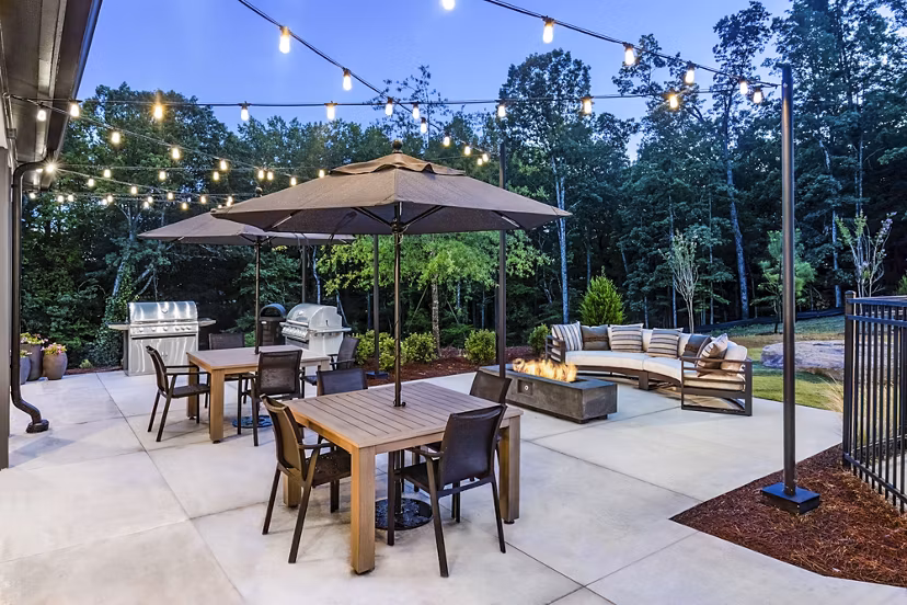 Outdoor fire pit and grill area on the patio at Elan Sweetwater Creek Apartments, ideal for social gatherings and relaxation