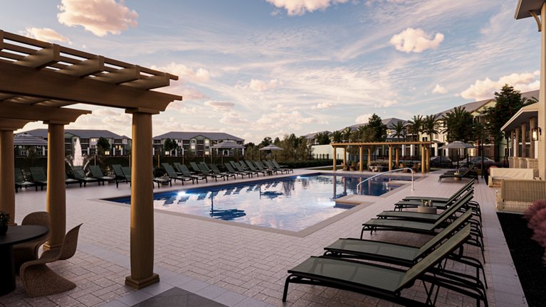 Outdoor pool area at modern apartment complex with lounge chairs and beautiful blue sky