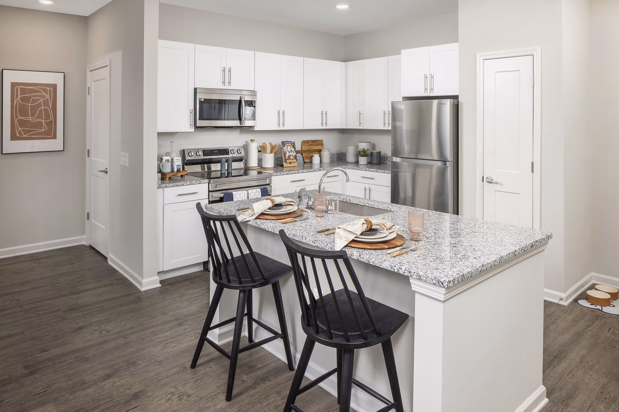 Modern kitchen featuring stainless steel appliances and granite countertops at Prose New Hope Apartments