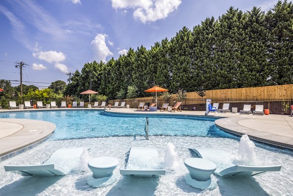 Elegant poolside retreat at Prose New Hope Apartments with lounge chairs and lush landscaping