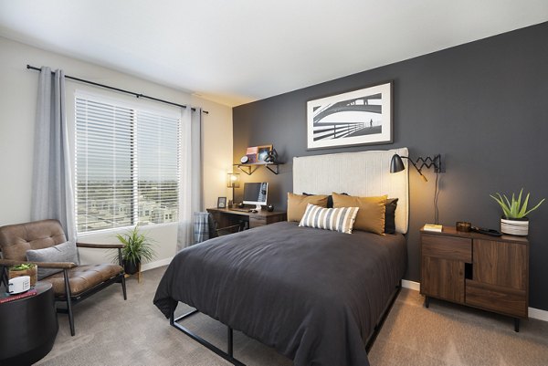 Cozy bedroom featuring modern decor and natural light in Prado Apartments