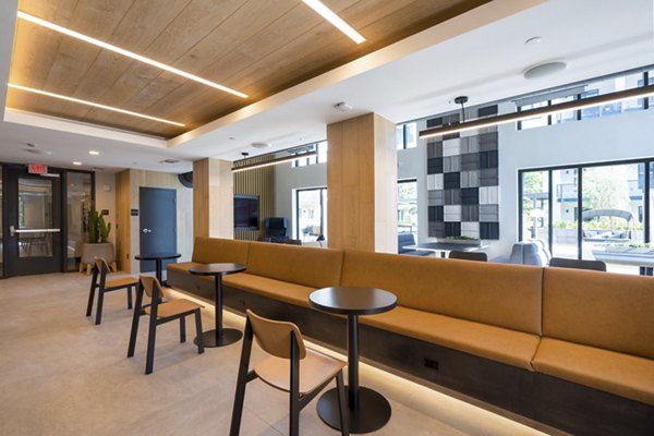 Clubhouse at Prado Apartments: Modern luxury facility with comfortable seating and fireplace in exclusive Greystar community