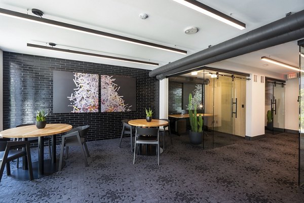 Clubhouse featuring modern seating and artwork at Prado Apartments, luxury living in a vibrant community