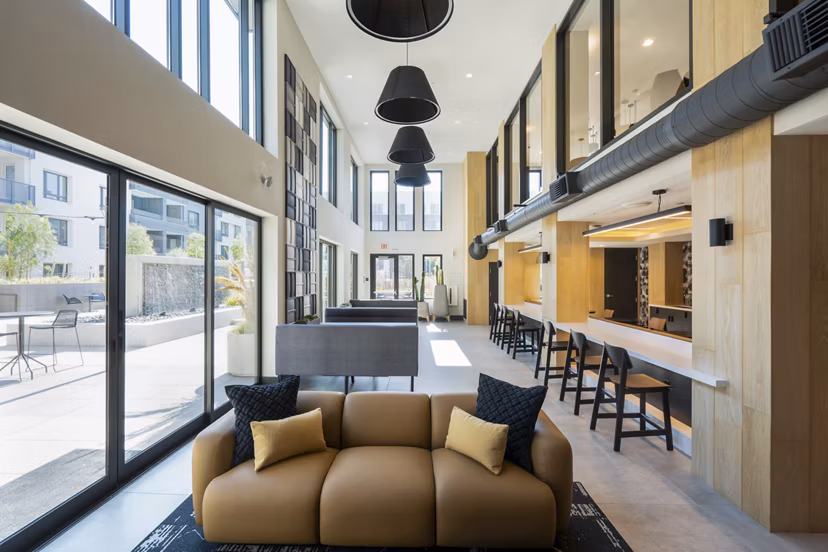 Modern clubhouse with lounge seating and billiards at Prado Apartments, a luxury community