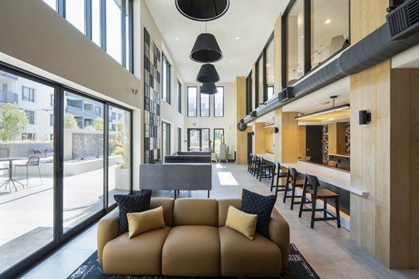 Modern clubhouse with lounge seating and billiards at Prado Apartments, a luxury community