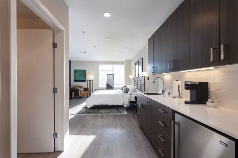 Modern kitchen with sleek appliances and island at Prado Apartments, offering luxury living spaces near city center