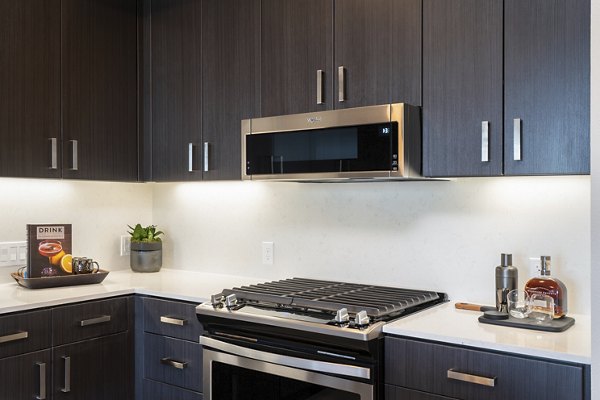 Modern kitchen with stainless steel appliances at Prado Apartments, Greystar luxury apartments in urban setting