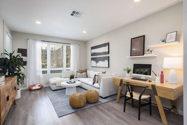 Bright living room with modern decor and large windows at Prado Apartments, a Greystar luxury community