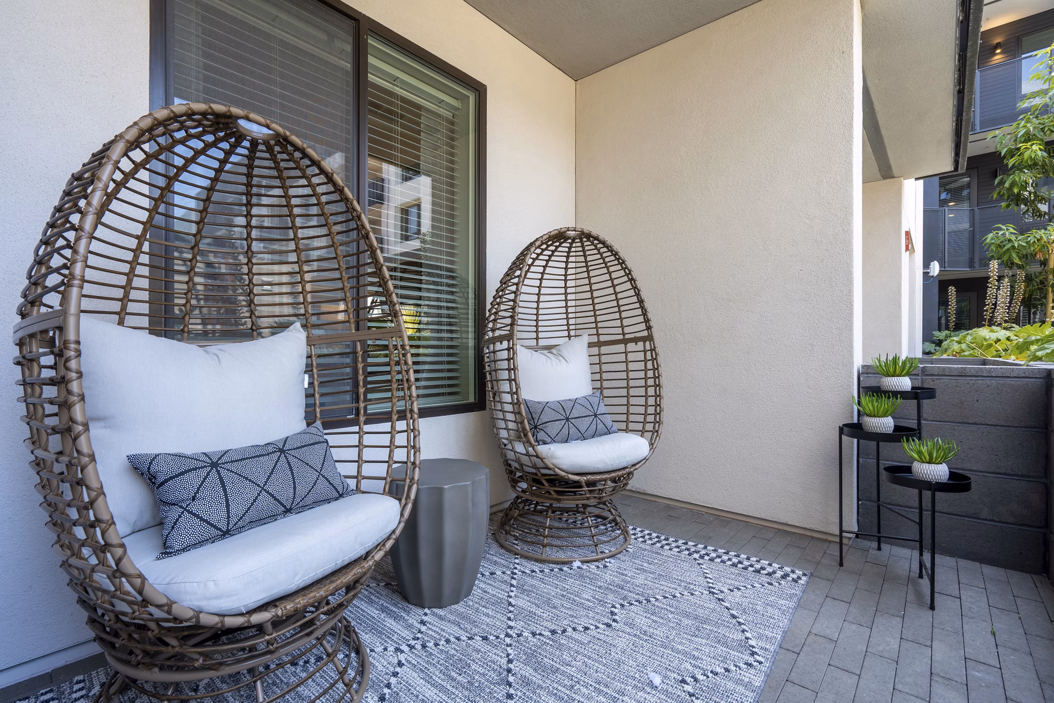 Patio with stylish outdoor seating at Prado Apartments offering relaxation spaces in luxury environment