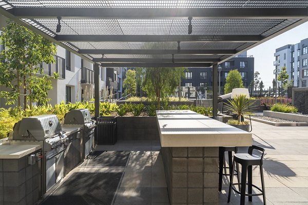 Outdoor grill area with modern BBQ stations at Prado Apartments, offering a luxurious amenity for residents to enjoy outdoor cooking