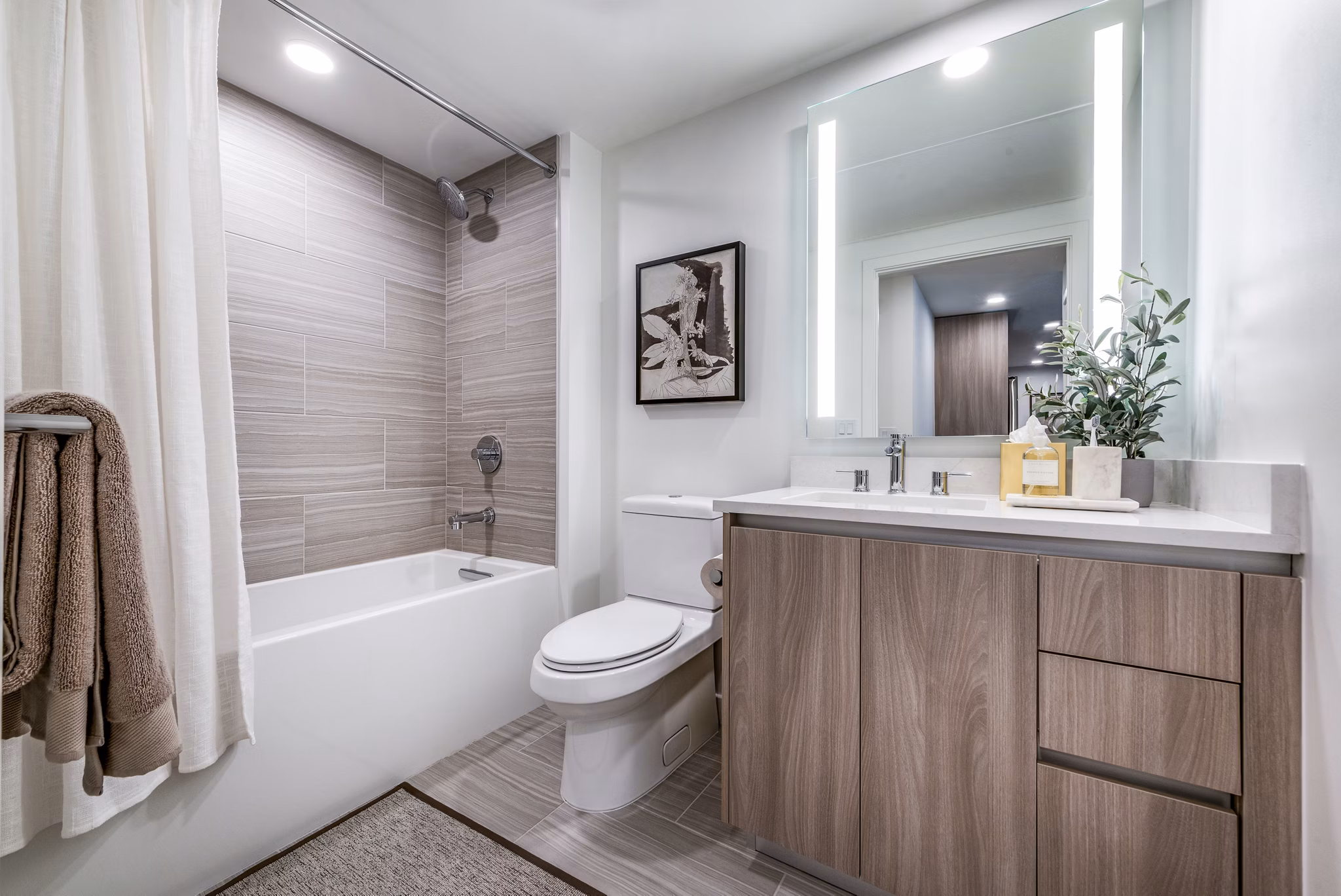 Modern bathroom featuring a stylish bathtub, shower, and elegant decor in luxury apartments
