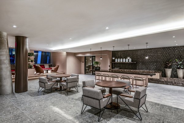 Modern lobby area with stylish seating and a counter in luxury apartments
