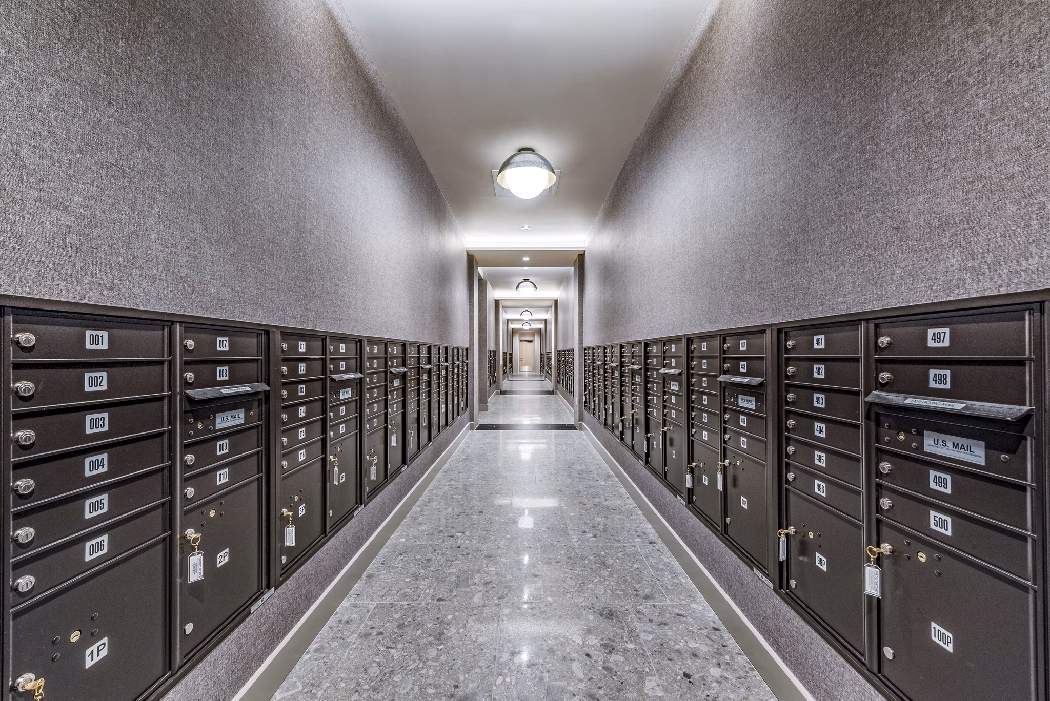 Hallway featuring rows of mailboxes in luxury apartments