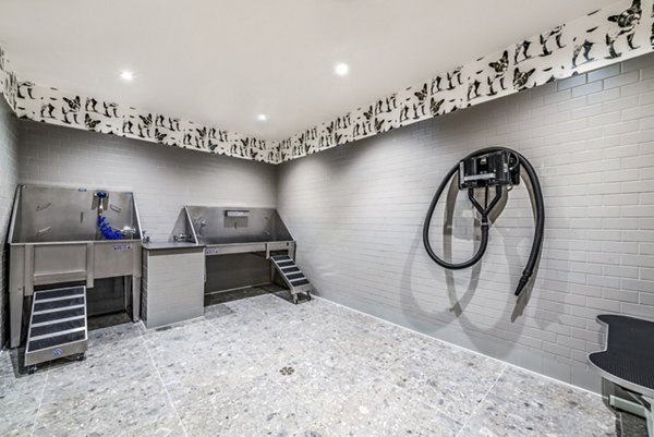Pet washing station with dual washing areas and convenient hose at luxury apartments