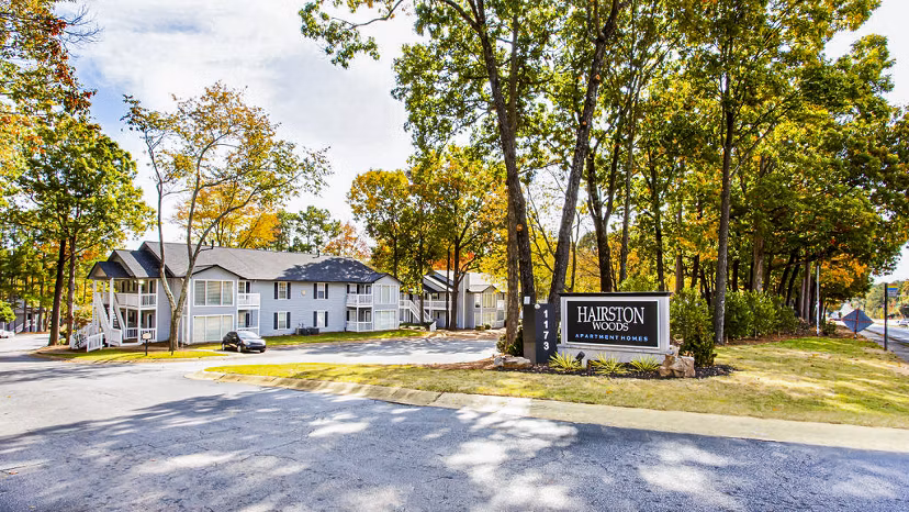 Signage at Hairston Woods Apartments: Modern entrance with vibrant community branding