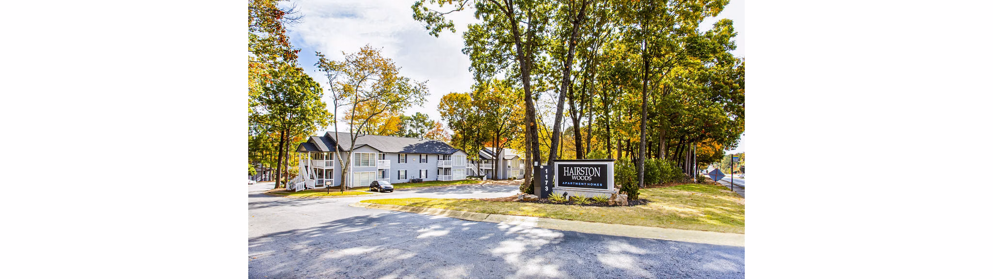 Signage at Hairston Woods Apartments: Modern entrance with vibrant community branding