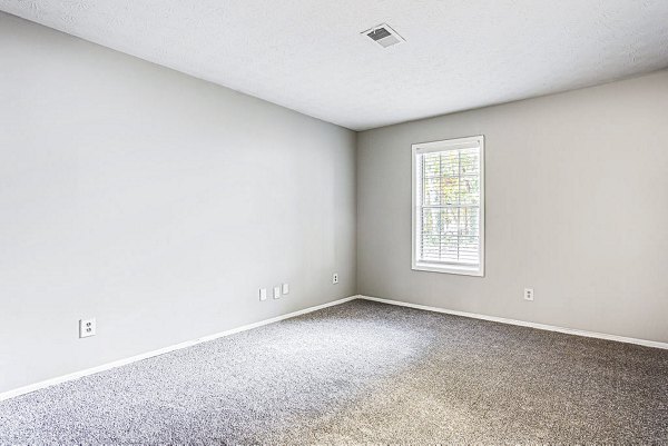 Cozy bedroom with modern decor in Hairston Woods Apartments