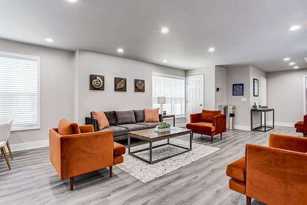 Upscale clubhouse with cozy seating area at Hairston Woods Apartments, ideal for community gatherings and events