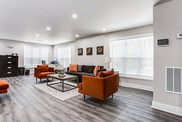 Clubhouse featuring modern design and comfortable seating at Hairston Woods Apartments in a Greystar community