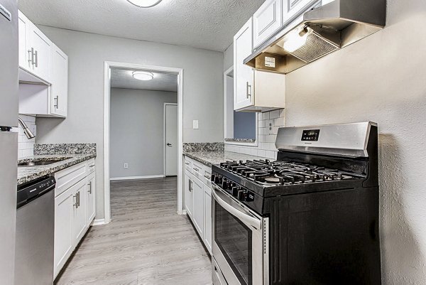 Modern kitchen with stainless steel appliances at Hairston Woods Apartments