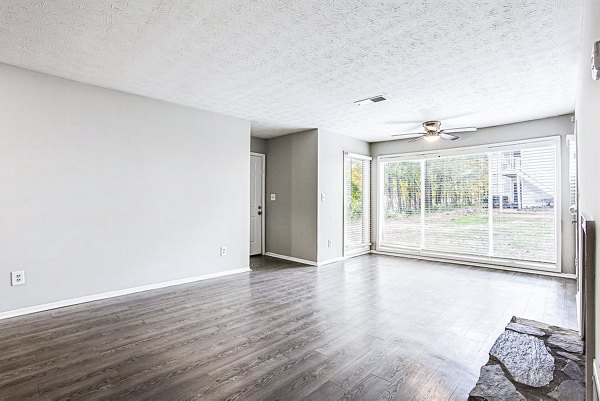 Spacious living room with modern decor at Hairston Woods Apartments