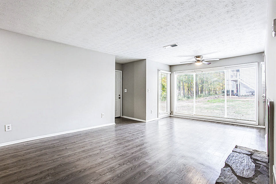 Spacious living room with modern decor at Hairston Woods Apartments