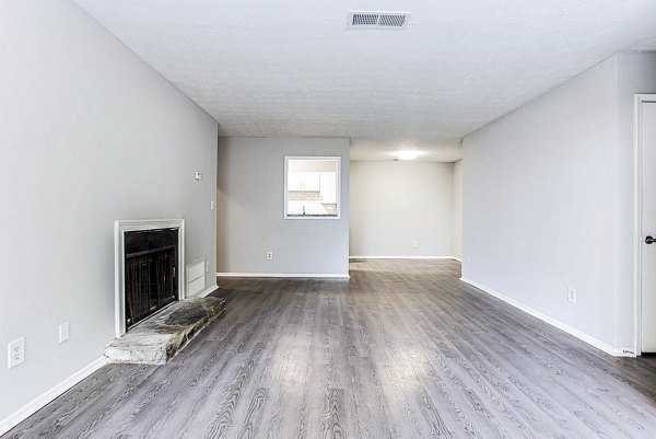 Spacious living room with modern furnishings in Hairston Woods Apartments
