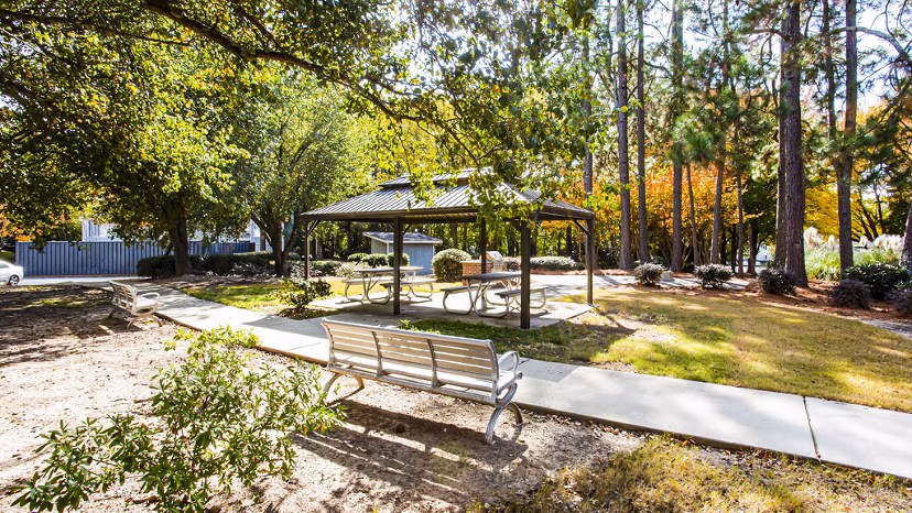 Grill area with outdoor seating at Hairston Woods Apartments patio, perfect for gatherings and leisure