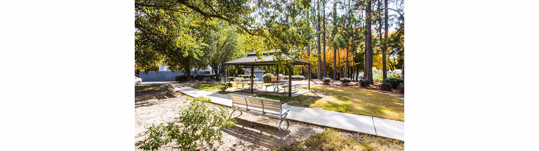 Grill area with outdoor seating at Hairston Woods Apartments patio, perfect for gatherings and leisure