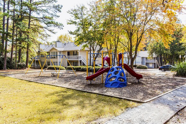 Playground for children at Hairston Woods Apartments featuring modern play equipment and safe surfaces