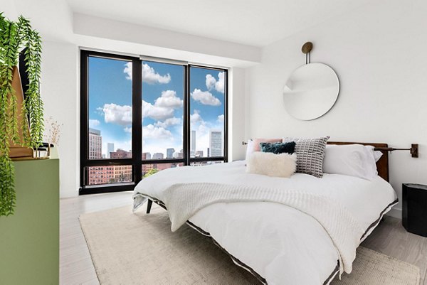 Bedroom featuring contemporary design and natural light at The Metlo Apartments
