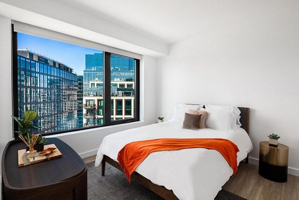 The Metlo Apartments: Cozy bedroom with modern decor and ample natural light