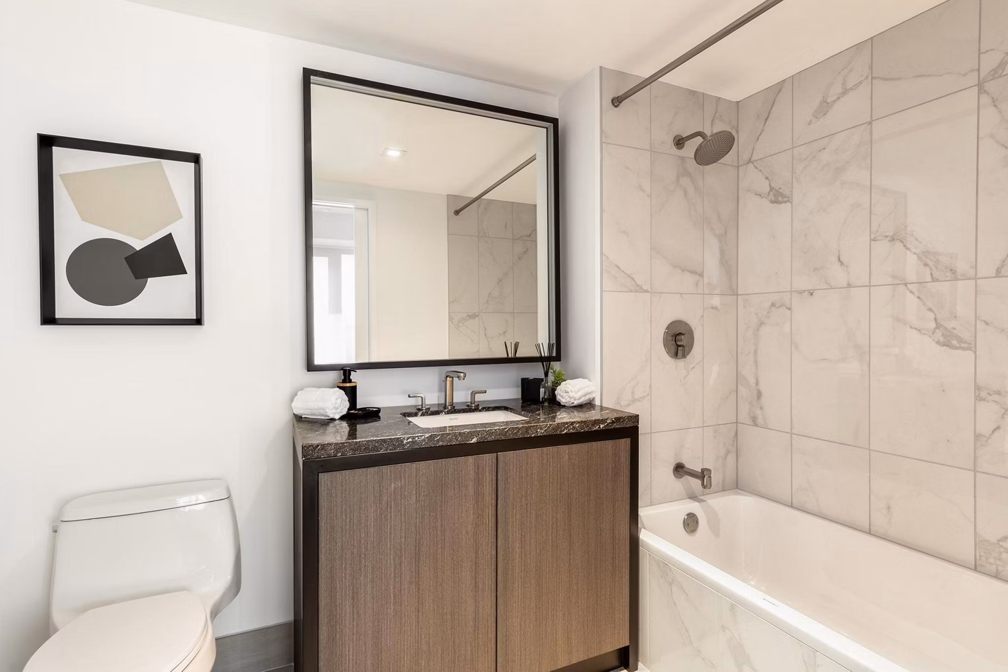 Bathroom featuring modern fixtures and elegant marble countertops at The Metlo Apartments
