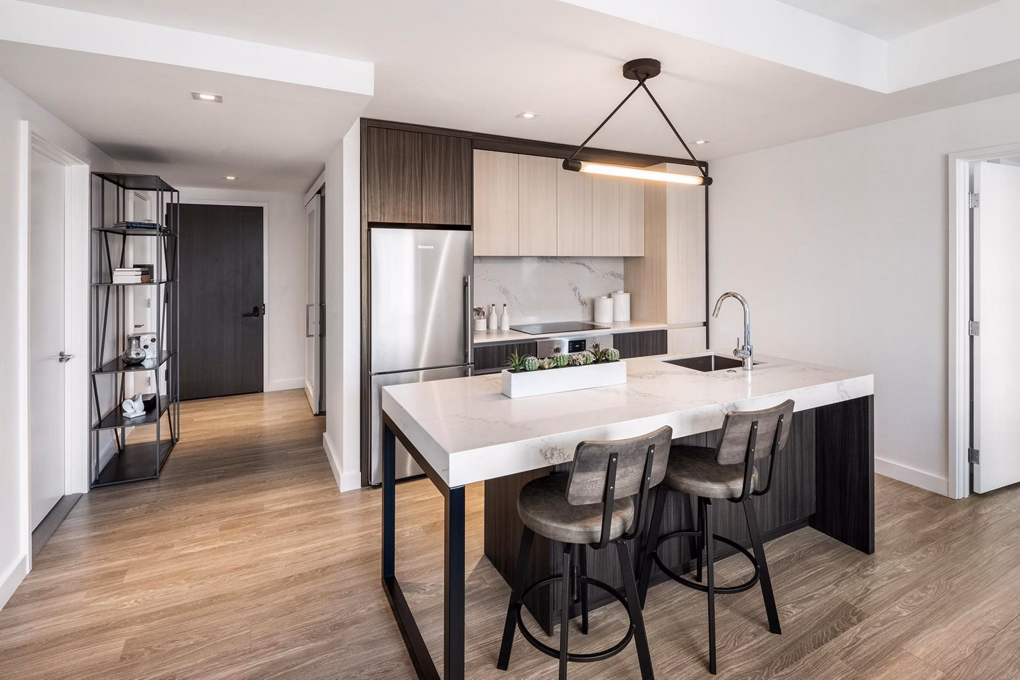 Modern kitchen with stainless steel appliances in The Metlo Apartments