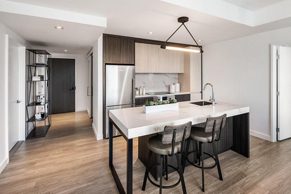 Modern kitchen with stainless steel appliances in The Metlo Apartments