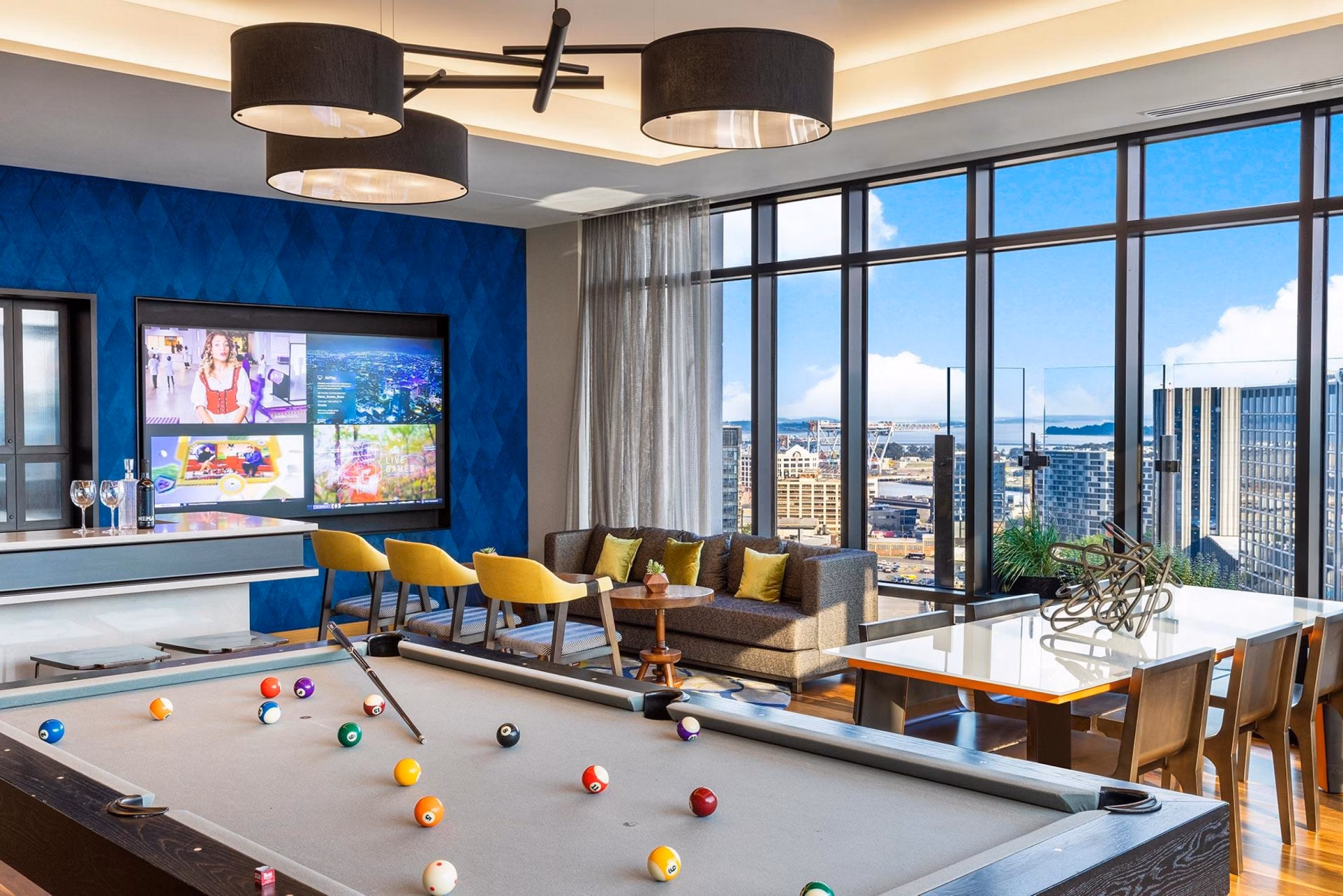 Exciting game room with billiards and arcade games at The Metlo Apartments, offering fun and entertainment in a luxury setting