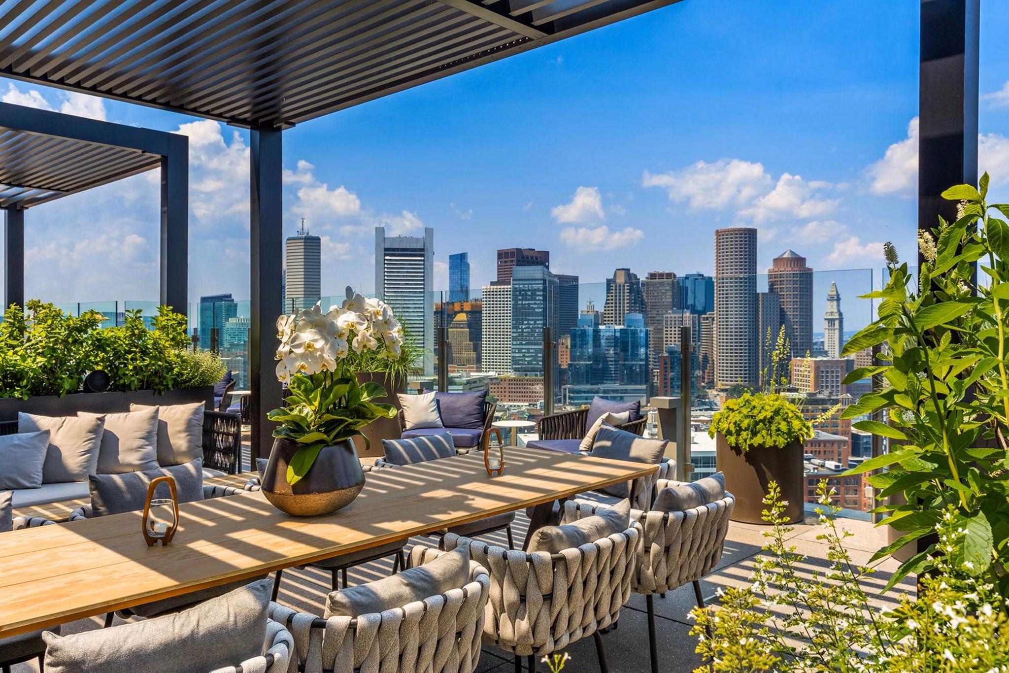 Scenic rooftop deck with seating and city views at The Metlo Apartments