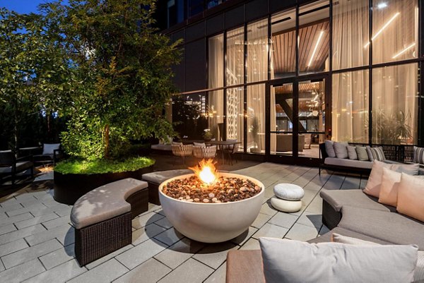 Outdoor seating and fire pit area at The Metlo Apartments, ideal for relaxation and social gatherings