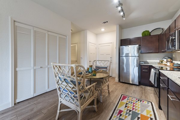 Dining area featuring modern decor and elegant lighting at Urban Crest Apartments