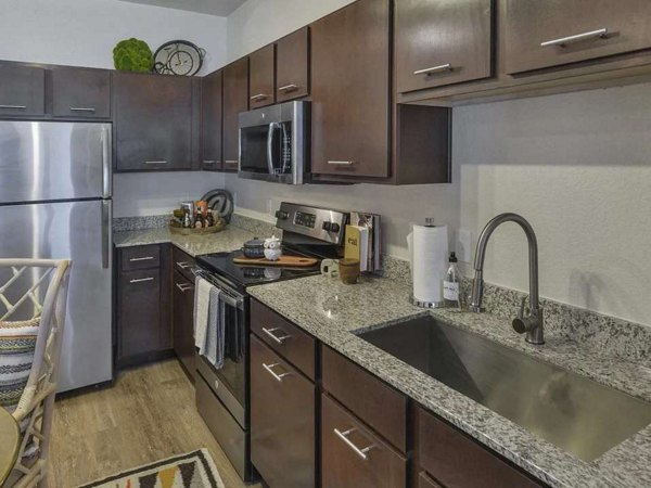 Spacious kitchen featuring modern appliances and sleek countertops in Urban Crest Apartments luxury apartments