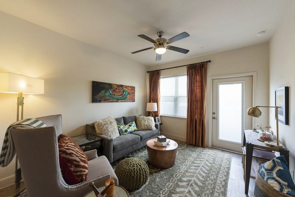 Living room with modern decor and sleek furniture at Urban Crest Apartments