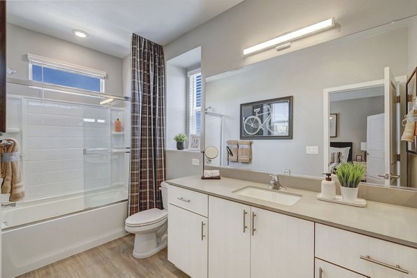 Modern bathroom with sleek fixtures and ample lighting at Town Germann Apartments, a luxury residence by Greystar