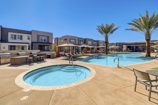 Relaxing hot tub with a gazebo at Town Germann Apartments' courtyard