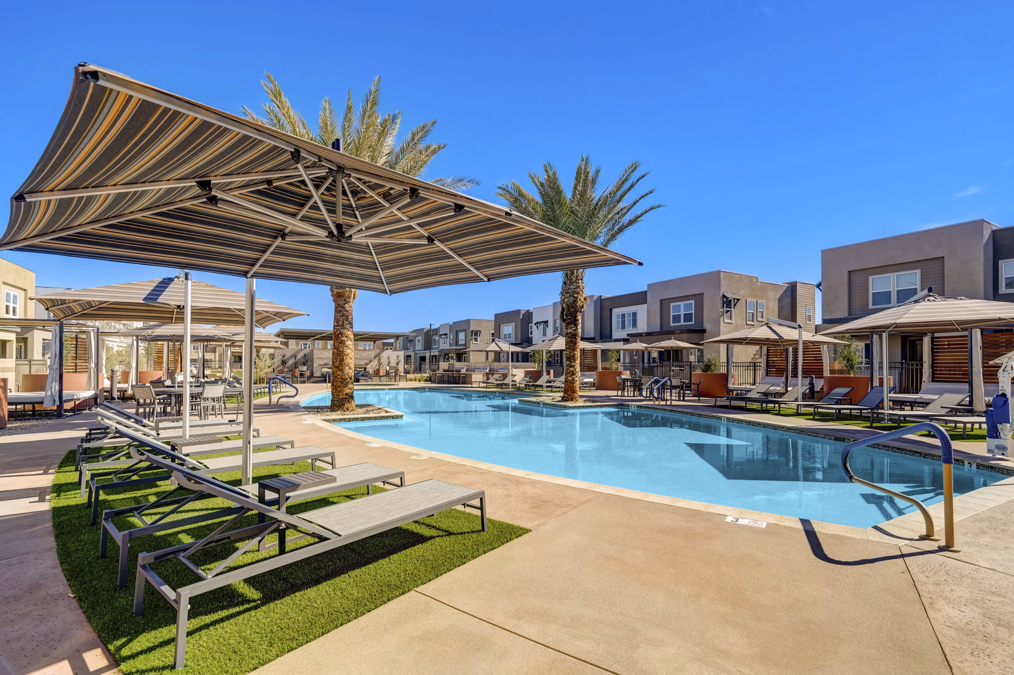 Rooftop pool with lounge chairs at Town Germann Apartments