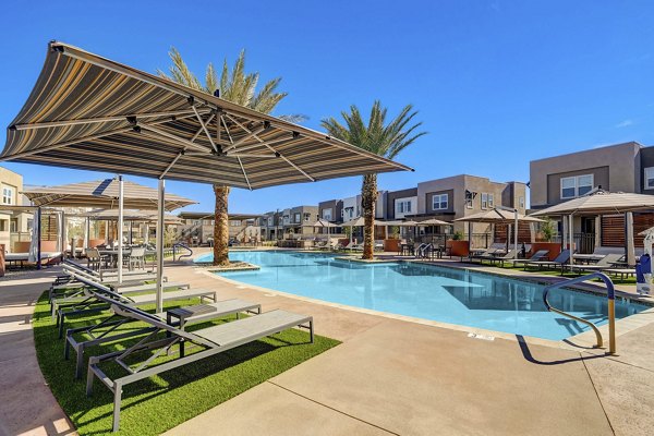 Rooftop pool with lounge chairs at Town Germann Apartments