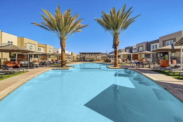 Resort-style pool with lounge chairs at Town Germann Apartments