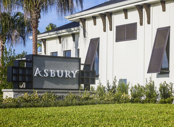 Asbury Apartments: Night view of modern signage at luxury property, showcasing elegant architectural design