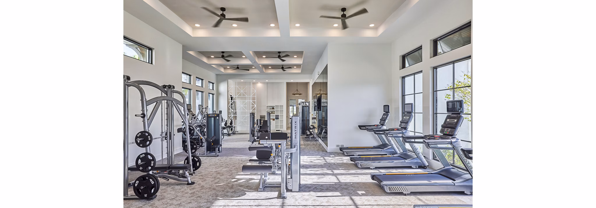 State-of-the-art fitness center featuring modern gym equipment at Asbury Apartments