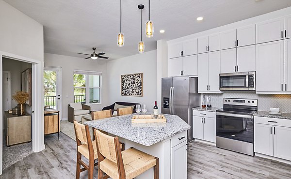 Dining room with modern kitchen appliances at Asbury Apartments, offering luxury living