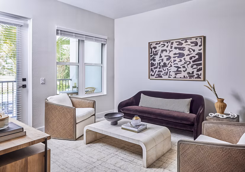 Spacious living room with large windows and contemporary decor in Asbury Apartments at Greystar luxury apartments